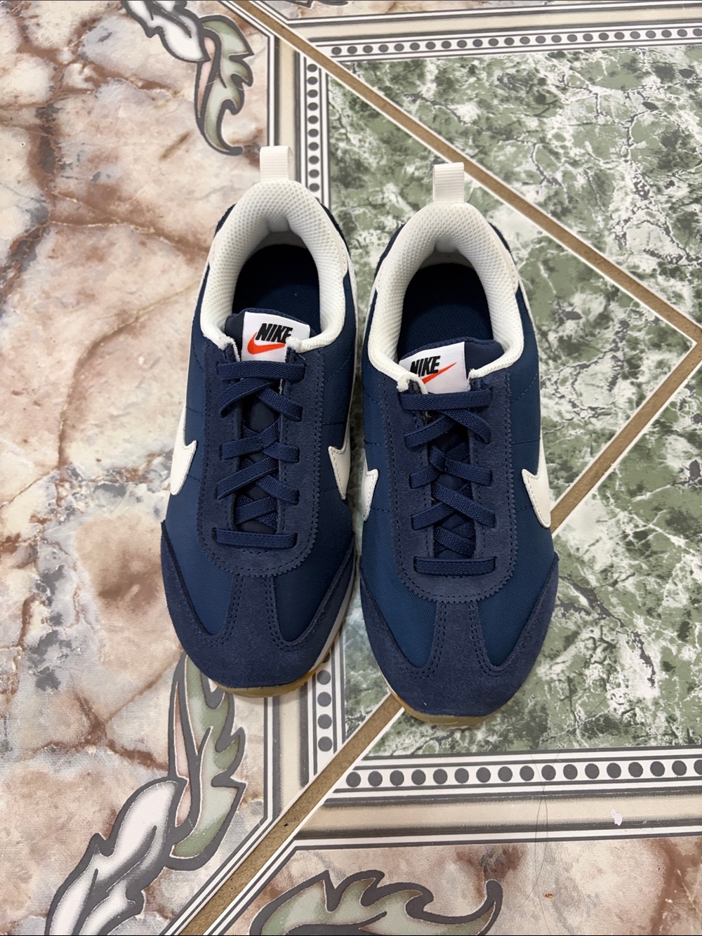 Nike Navy and White Kids Sneakers with Orange Logo Accent